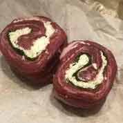 Photo of Allow the pinwheels to sit on a plate at room temperature for about 30 minutes before cooking.